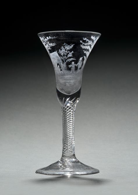 An English air twist goblet with a Chinoiserie scene in the wheel  engraving technique.