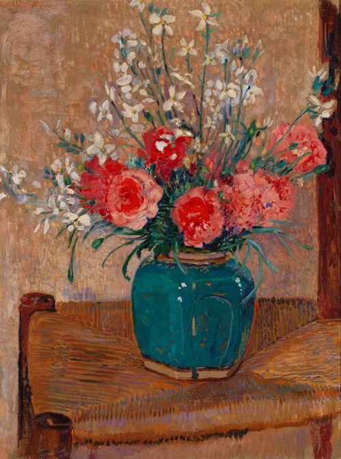 Flowers in a pot on a cane chair